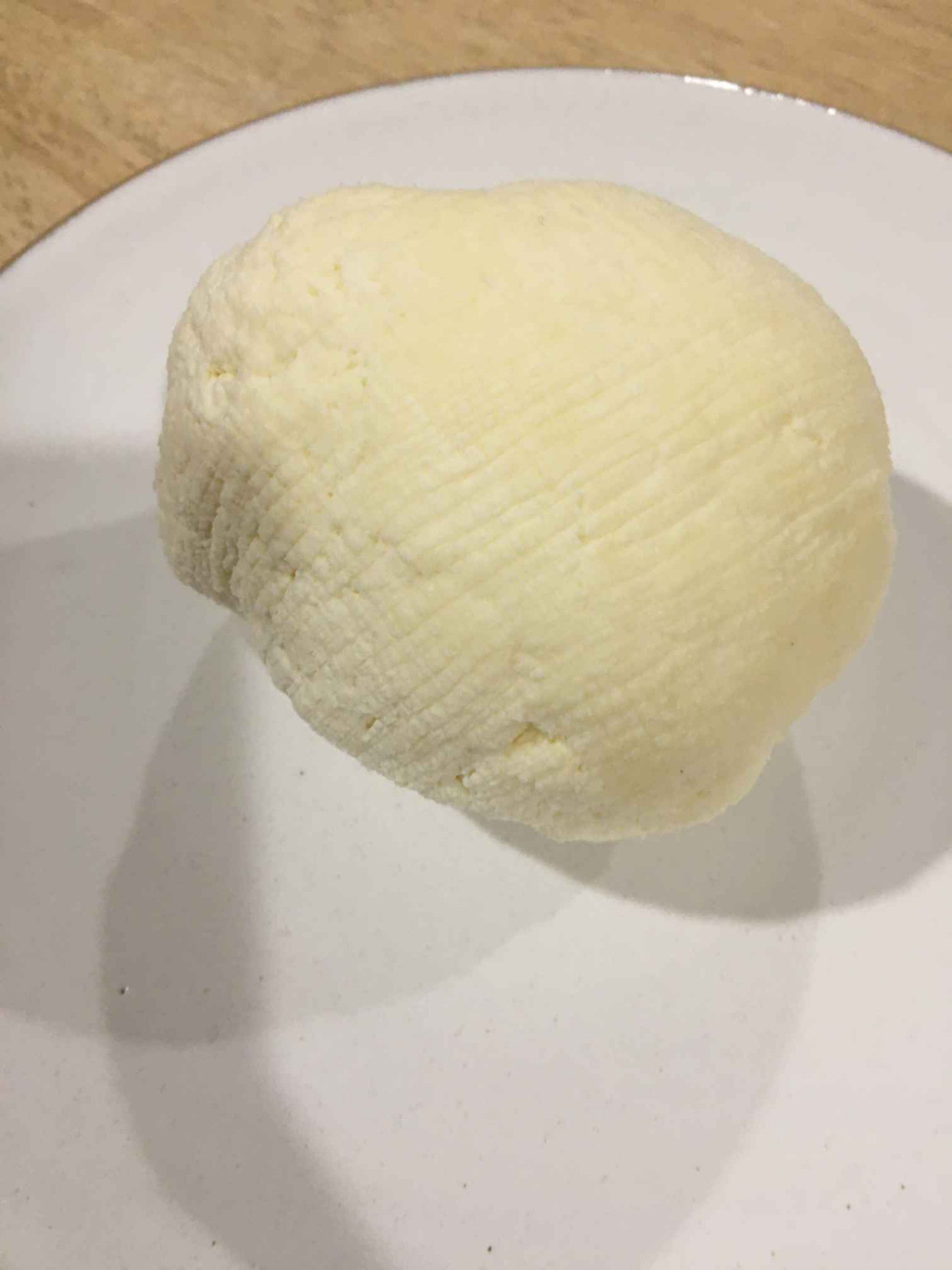 formed ball of cheese on plate